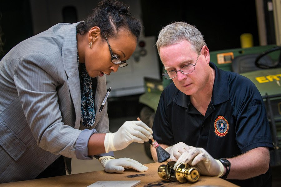 An FBI Jacksonville Citizens Academy particpant learns the tools and techniques of recovering latent print evidence during an introduction to the FBI’s Evidence Response Team.